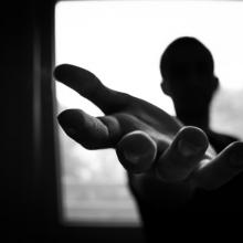 man's hand in shallow focus and grayscale photography 